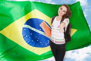 Young smiling female student over the Brazilian flag